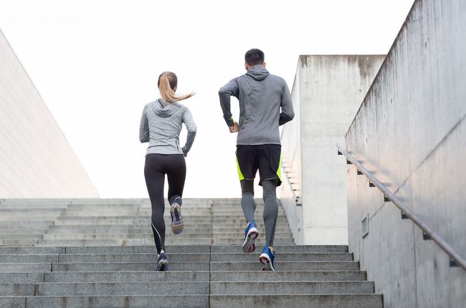 A man and a woman running to improve cardiovascular health.