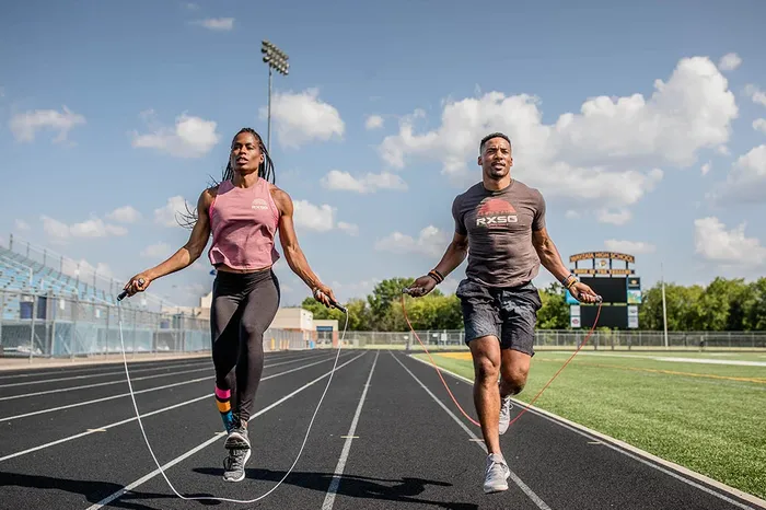 A man and a woman running on a track - What’s a Good Heart Rate Variability? Understanding Your HRV