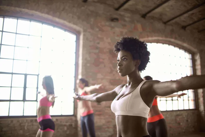 a group of women doing yoga in a gym - Exercise Before Blood test & More