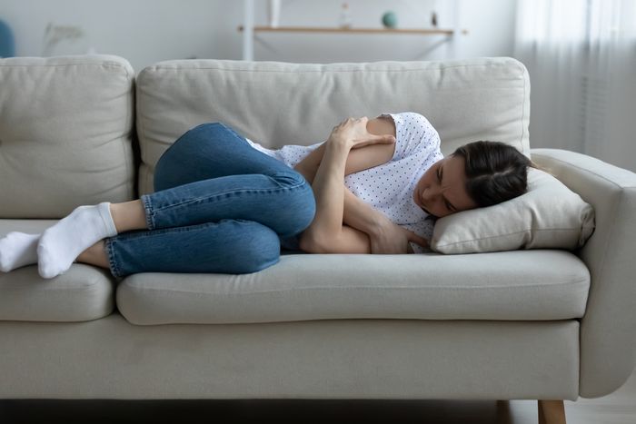 Inflammation and depression: a sad woman lying on the couch.